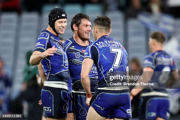 Matt Burton, Josh Jackson and Kyle Flanagan of the Bulldogs celebrates at full time during the round 25 NRL match between the Canterbury Bulldogs and...