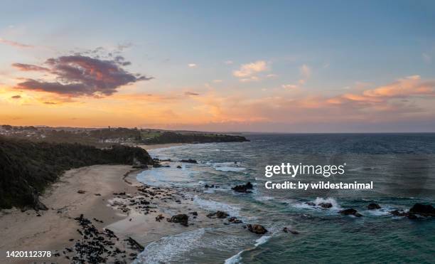 aerial view of surf beach  and cemetery beach at sunset, narooma, nsw, australia. - bay of water stock pictures, royalty-free photos & images