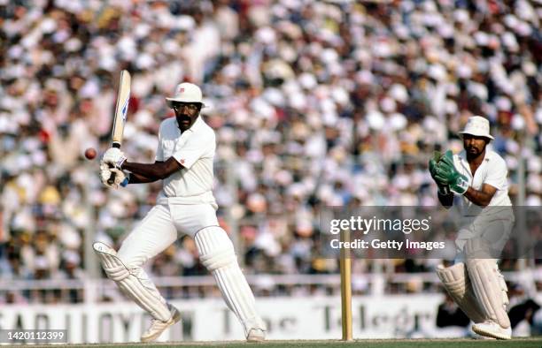 West Indies batsman Clive Lloyd in batting action during his first innings century watched by wicketkeeper Syed Kirmani during the 5th Test Match...