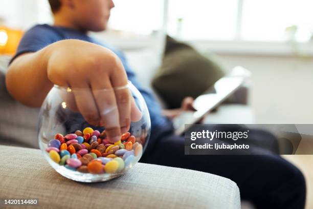 boy reaching for the colorful sprinkles - fat loss stock pictures, royalty-free photos & images