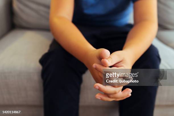 teen sitting on a sofa at home, having a therapy session with a counsellor - chubby teen boy stock pictures, royalty-free photos & images