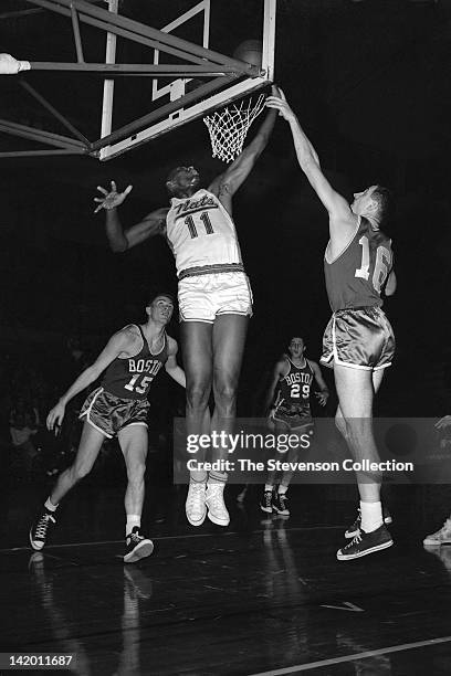Earl Lloyd of the Syracuse Nationals shoots against Jack Nichols of the Boston Celtics circa 1958 at the Onondaga War Memorial Arena in Syracuse, New...