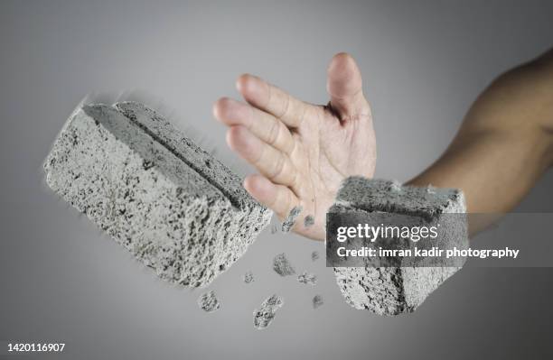 hands break the  bricks - punching wall stock pictures, royalty-free photos & images