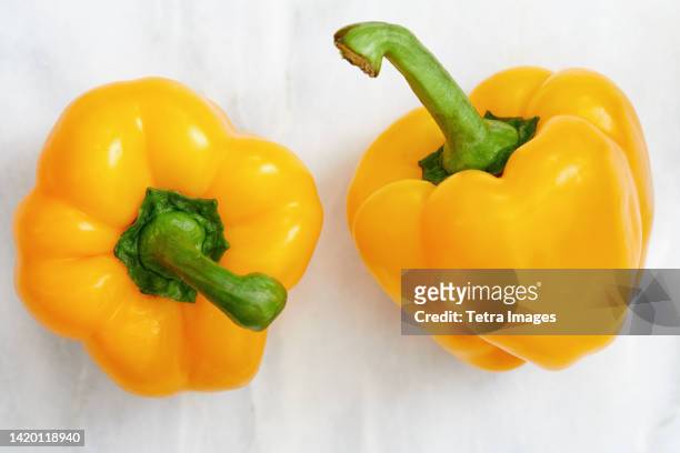 studio shot of two yellow bell peppers - yellow bell pepper stock pictures, royalty-free photos & images