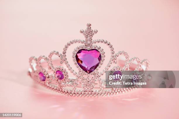studio shot of tiara with artificial pink gemstones - diadem stock-fotos und bilder