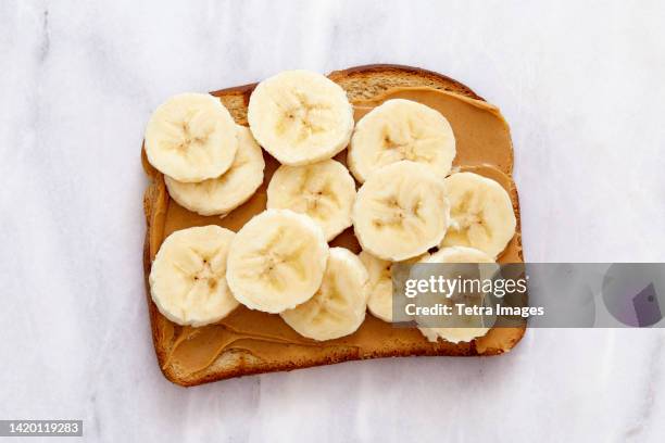 overhead view of peanut butter and banana toast - peanut butter toast stock pictures, royalty-free photos & images