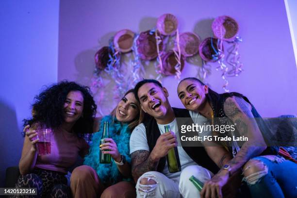 friends watching tv while drink beer at a party - friends tv show stock pictures, royalty-free photos & images