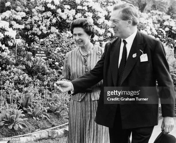 Queen Elizabeth II on a tour of the Chelsea Flower Show, London, 19th May 1980.