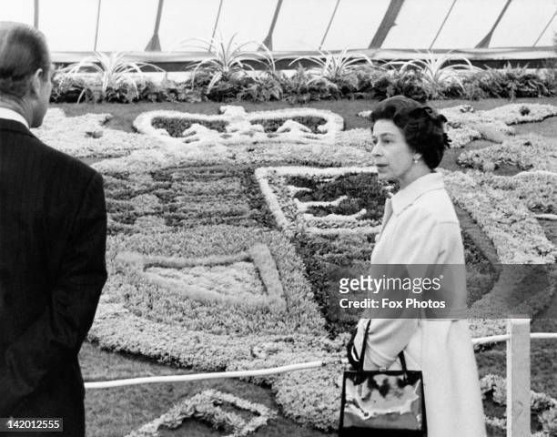 Queen Elizabeth II and Prince Philip viewing the carpet bedding of the Royal Coat of Arms, during a tour of the Chelsea Flower Show, London, 19th May...
