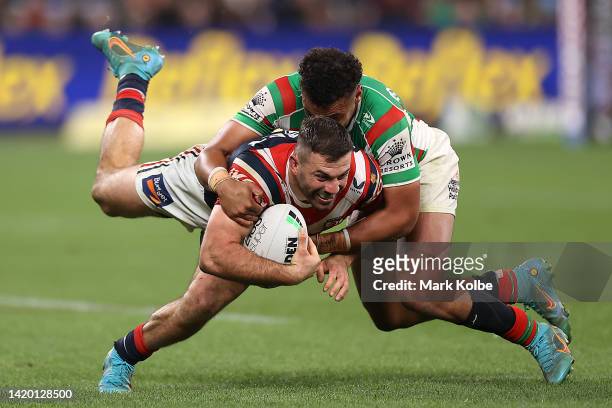 James Tedesco of the Roosters is tackled during the round 25 NRL match between the Sydney Roosters and the South Sydney Rabbitohs at Allianz Stadium...