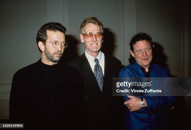 Eric Clapton beside an unidentified man and Jack Bruce during 8th Annual Rock and Roll Hall of Fame Induction at Century Plaza Hotel in Century City,...