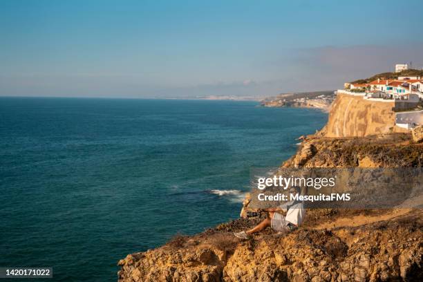 photographer on the cliff - azenhas do mar stock pictures, royalty-free photos & images