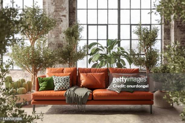 umweltfreundliches wohnzimmer mit ledersofa, grünen pflanzen und ziegelmauer - boho stock-fotos und bilder