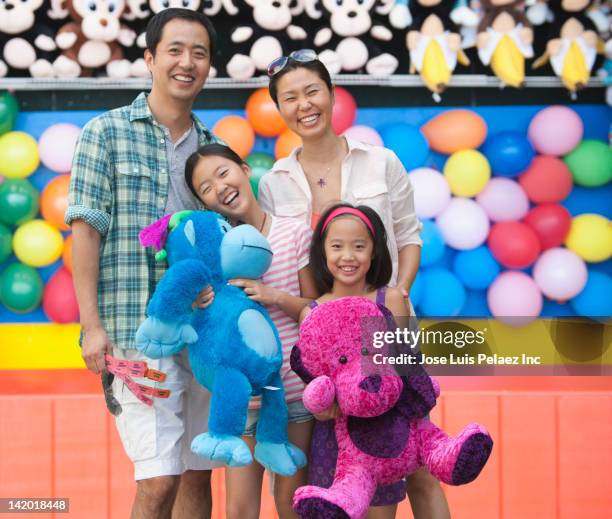 family enjoying amusement park - animal win fotografías e imágenes de stock