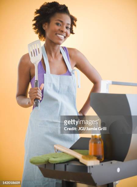black woman grilling on barbecue - apron isolated stockfoto's en -beelden