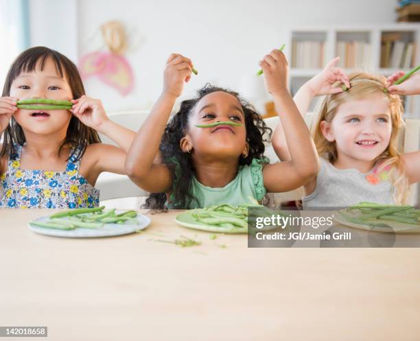 girls playing with green beans - runner beans stock pictures, royalty-free photos & images
