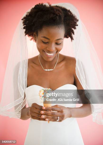black bride in wedding dress holding ice cream cone - black veil brides stock pictures, royalty-free photos & images