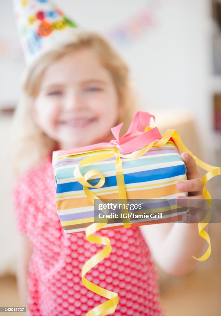 Caucasian girl holding birthday gift