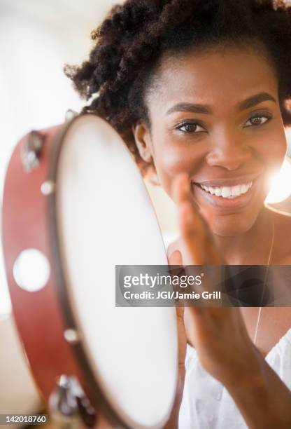 black woman holding tambourine - hitting drum stock pictures, royalty-free photos & images