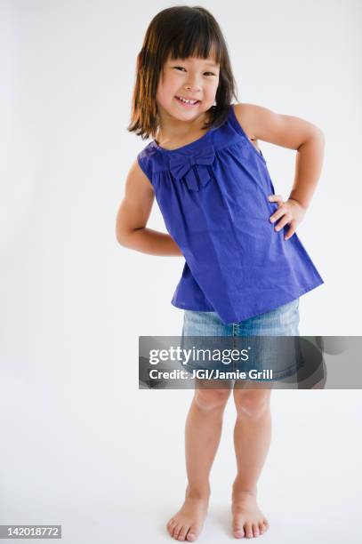 smiling korean girl with hands on hips - girls on white background stock pictures, royalty-free photos & images