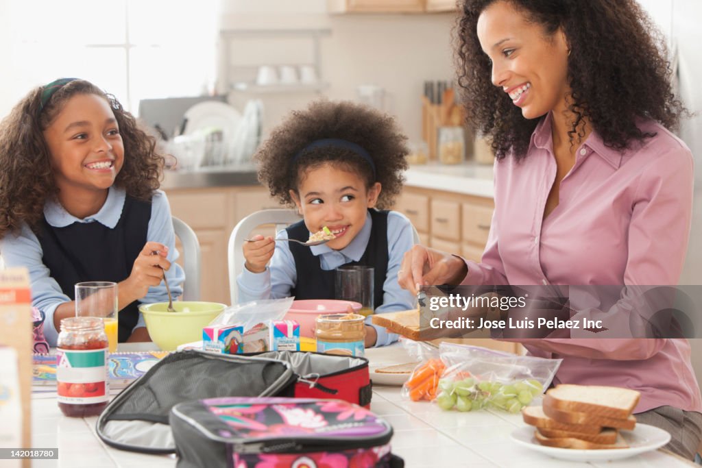 Mixed race mother preparing daughter's lunch