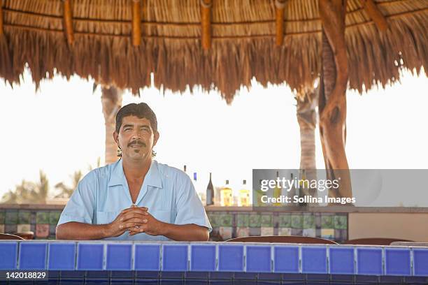 hispanic bartender standing behind bar - mexican mustache stock pictures, royalty-free photos & images