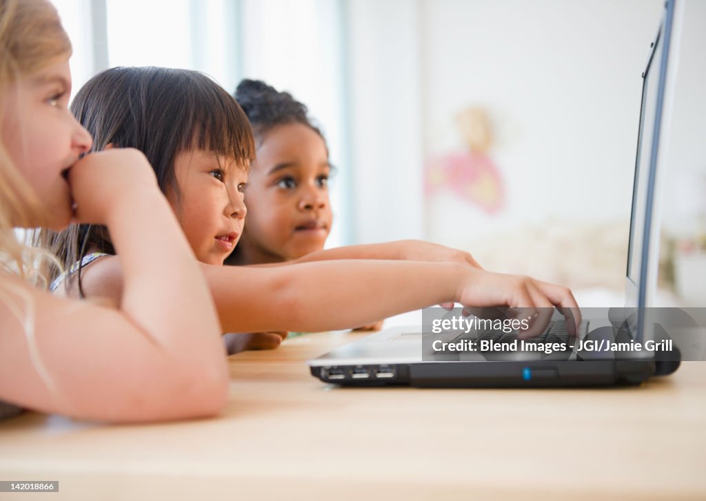 Girls using laptop together