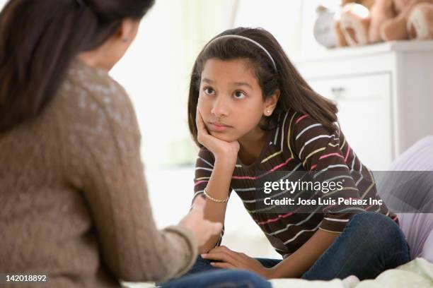mother talking to daughter in bedroom - mom head in hands stock pictures, royalty-free photos & images