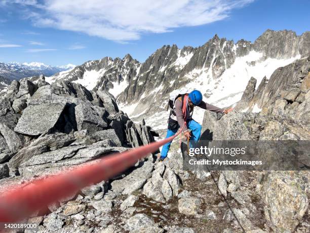 climbing rope leads to mountain guide on glacier - extreme sports point of view stock pictures, royalty-free photos & images