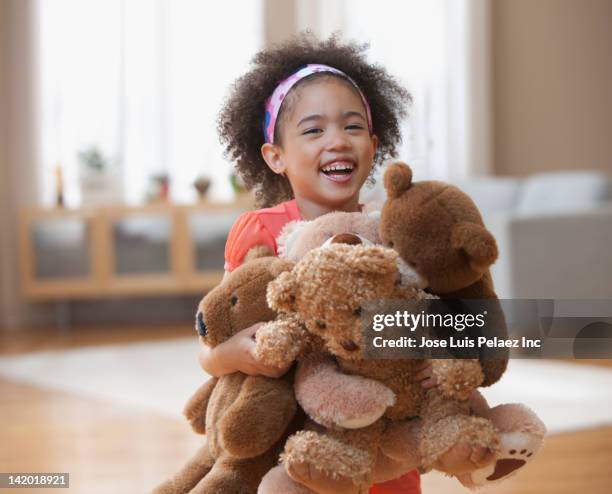 mixed race girl holding teddy bears - child teddy bear stock pictures, royalty-free photos & images