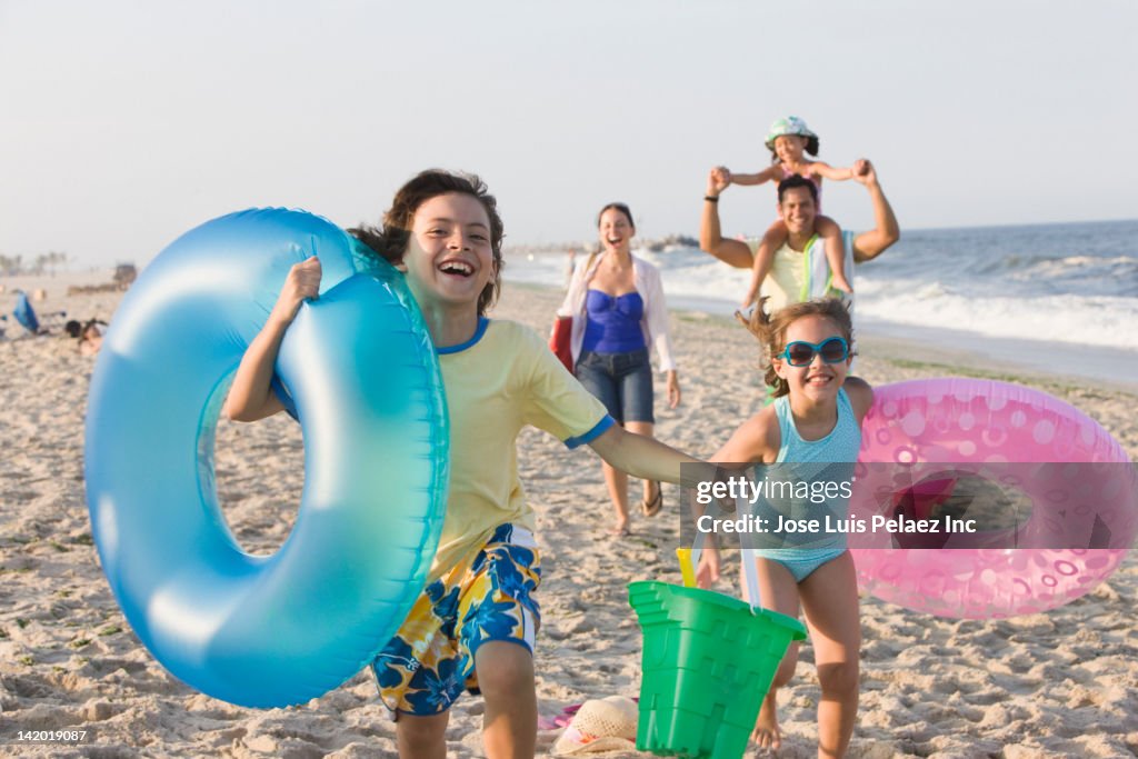 Hispanic family enjoying beach together