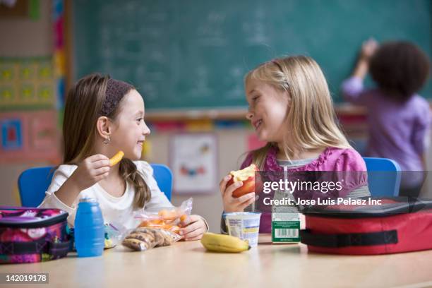 students eating lunch in classroom - school lunch table stock pictures, royalty-free photos & images