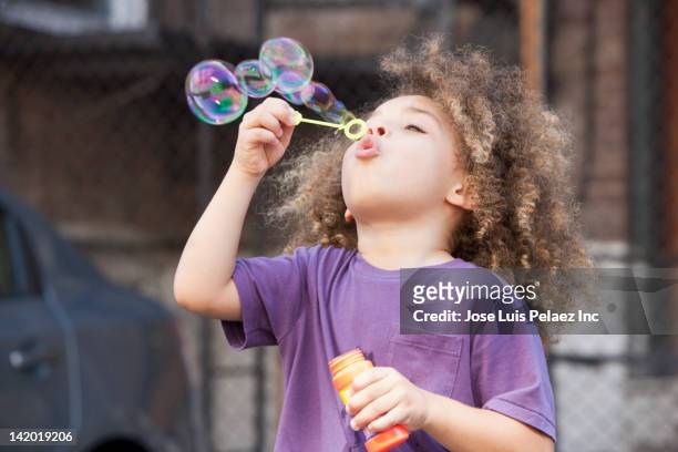 mixed race boy glowing bubbles - child bubble stock pictures, royalty-free photos & images