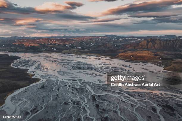 aerial image showing a braided river flowing through the icelandic highlands at sunset, iceland - braided river stock pictures, royalty-free photos & images