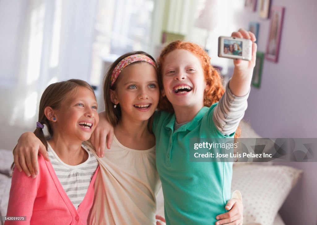 Girls taking self-portrait with digital camera