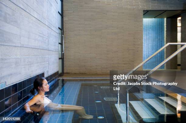 hispanic woman soaking in hot tub - daylesford victoria stock pictures, royalty-free photos & images