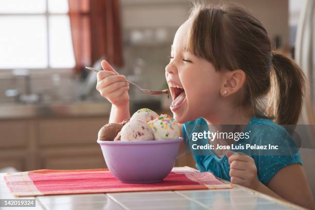 caucasian girl eating bowl of ice cream - スプーン ストックフォトと画像