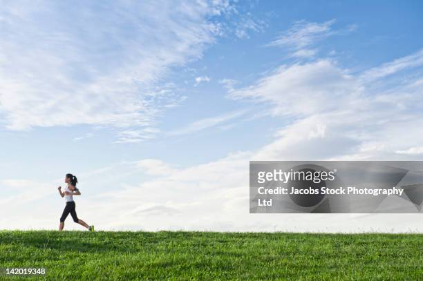 chinese woman running on hill - grass hill stock pictures, royalty-free photos & images