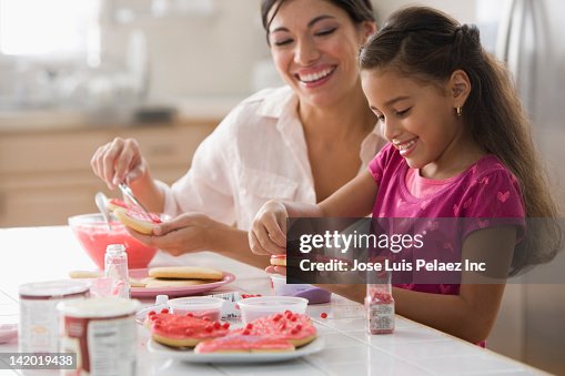 Mother and daughter making Valentine's cookies Mother and daughter making Valentine's cookies