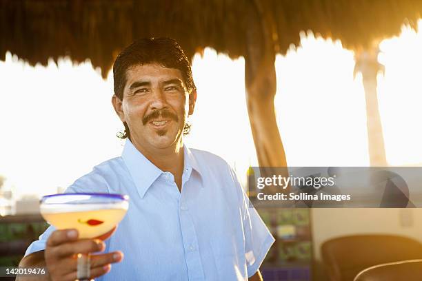 hispanic bartender serving cocktail - outdoor bartender stock pictures, royalty-free photos & images