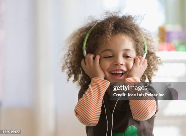 mixed race boy listening to headphones - boy ipod stock pictures, royalty-free photos & images