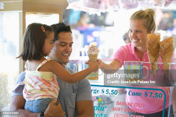 waitress handing girl ice cream cone - eiscreme kaufen stock-fotos und bilder