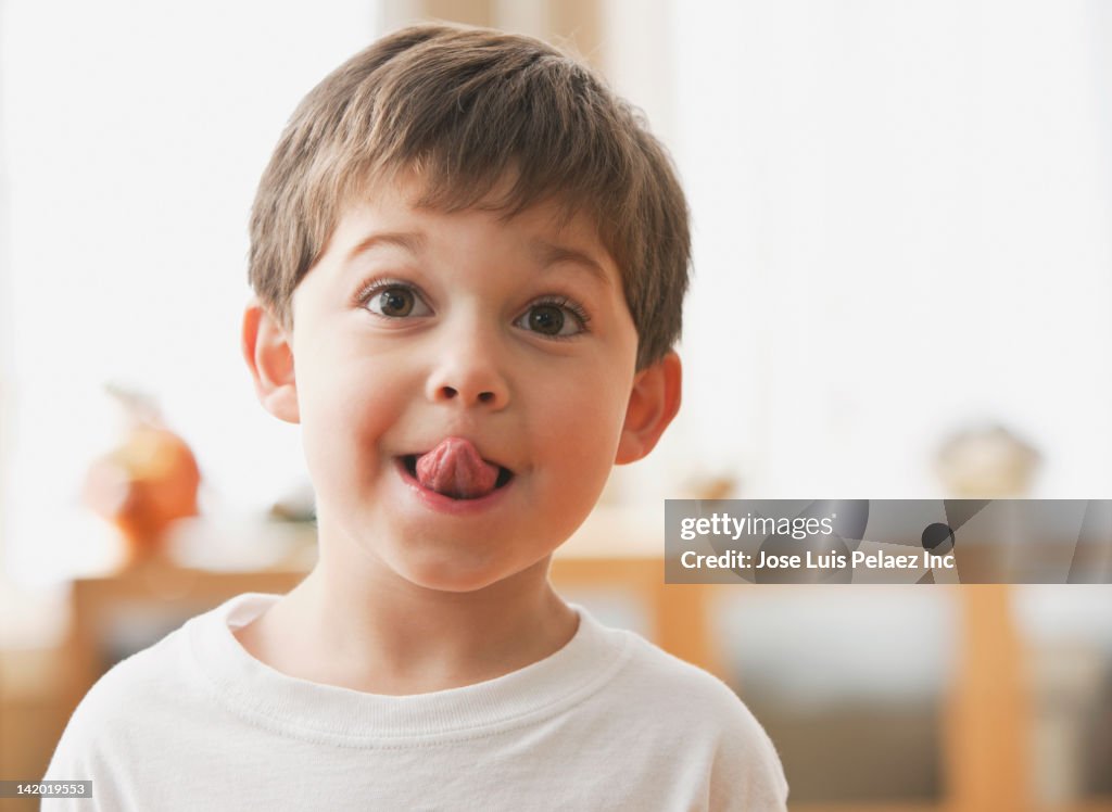 Cute Caucasian boy sticking out tongue