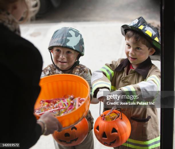 caucasian boys trick or treating on halloween - east region sweet stock pictures, royalty-free photos & images