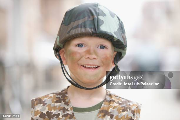 caucasian boy dressed in soldier halloween costume - army helmet stock pictures, royalty-free photos & images