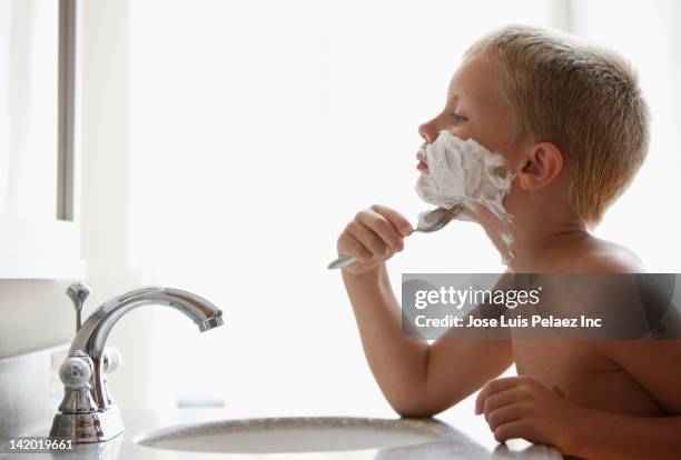 caucasian boy pretending to shave his face - shaving cream stock pictures, royalty-free photos & images