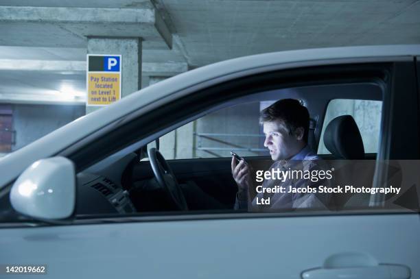 caucasian businessman using cell phone in car - white night melbourne stock pictures, royalty-free photos & images