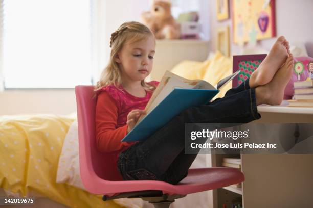 caucasian girl reading book with feet up - barefoot girl stock pictures, royalty-free photos & images