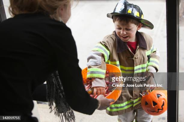 caucasian boy trick or treating on halloween - east region sweet stock pictures, royalty-free photos & images