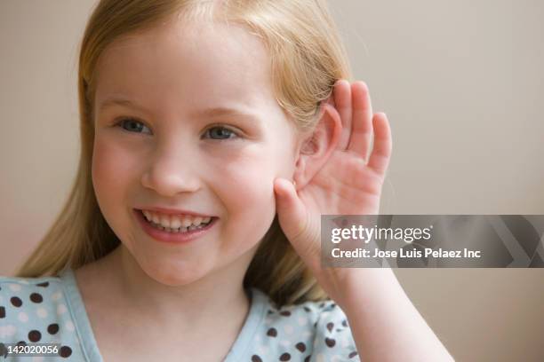 girl cupping ear to hear better - kid eavesdropping stock pictures, royalty-free photos & images